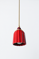 jasper red art deco pendant light with ribbed ceramic shade, powdercoated black cherry ball, and brass hardware. Beautiful rich red hanging pendant light handmade in new orleans by Sazerac Stitches.