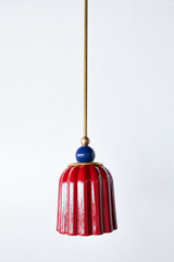 jasper red art deco pendant light with ribbed ceramic shade, powdercoated navy blue ball, and brass hardware. Beautiful rich red hanging pendant light handmade in new orleans by Sazerac Stitches.
