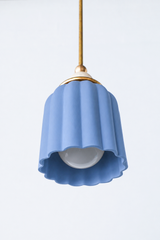 unglazed blue ceramic pendant light with cream powdercoated accent ball and brass hardware. Modern and colorful pendant light with a ceramic shade