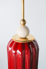 Rich, jewel tone red ceramic ceiling pendant with brass hardware and a cream powdercoated ball. Inspired by art deco glass with updated modern accents. This beautiful pendant light adds color and shape to any space. 