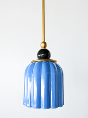 pastel light blue celadon-style glazed ribbed pendant light with glossy black powdercoated ball and brass hardware.  Art deco inspired pendant light fixture. Made in New Orleans by Sazerac Stitches. Mermaid green is similar to emerald green. 