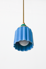 pastel light blue celadon-style glazed ribbed pendant light with mermaid green powdercoated ball and brass hardware.  Art deco inspired pendant light fixture. Made in New Orleans by Sazerac Stitches. Mermaid green is similar to emerald green. 