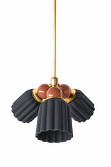 A small chandelier with matte, fluted ceramic cone shades in unglazed black, paired with glossy fudge brown powder-coated steel balls and brass hardware. The warm brown balls bring an earthy richness against the flat matte black, a grounded alternative to a brighter colorway. A strong pick for a moody dining room, a den, or a space leaning warm and traditional rather than bright or playful.
