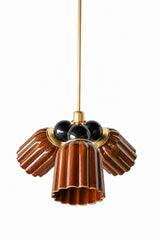 A small chandelier with glossy, glazed fluted ceramic cone shades in chicory brown, paired with glossy black powder-coated steel balls and brass hardware. The black balls bring real drama against the warm brown glaze, the moodiest and most serious pairing in this colorway lineup. A strong fit for a masculine traditional dining room, a dark-painted study, or any space that wants weight and contrast rather than a softer, brighter palette.