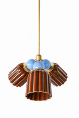A small chandelier with glossy, glazed fluted ceramic cone shades in chicory brown, paired with soft hydrangea blue powder-coated steel balls and brass hardware. The cool blue balls bring a gentle contrast against the warm brown glaze, a good pairing for a traditional dining room or entry that wants color without going fully saturated in one direction.