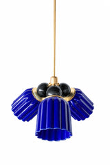 A small chandelier with deep, glossy cobalt fluted ceramic cone shades, paired with glossy black connector balls and brass hardware. The black balls add weight and drama against the saturated blue, a confident, graphic pairing for a moody dining room or a bold maximalist space.