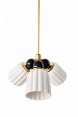 A small chandelier with matte, fluted ceramic cone shades in unglazed cream, paired with glossy black connector balls and brass hardware. The high contrast between the chalky cream and the glossy black gives this a graphic, sophisticated edge, a strong pick for a transitional dining room, a moody entry, or any space that wants real contrast without going fully dark.