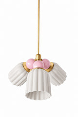 A small chandelier with matte, fluted ceramic cone shades in unglazed cream, paired with soft blush pink connector balls and brass hardware. The chalky neutral shades let the blush balls bring a gentle pop of color, a good fit for a nursery, a romantic bedroom, or a grandmillennial-leaning space that wants delicate pink without reading overly sweet.