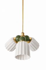 A small chandelier with matte, fluted ceramic cone shades in unglazed cream, paired with deep olive green connector balls and brass hardware. The soft, chalky neutral shades let the earthy green balls do the color work, a good fit for an English cottage dining room, a traditional library, or any space that wants natural, grounded color without going fully saturated.