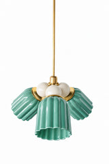 A small chandelier with glossy, glazed fluted ceramic cone shades in jade green, paired with cream connector balls and brass hardware. The soft cream balls bring contrast and a bit of restraint against the saturated green, a versatile pairing for a traditional dining room, a conservatory-style space, or anywhere that wants real color without going bold in every element.