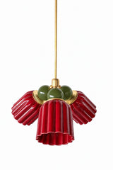 A small chandelier with deep, glossy jasper red fluted ceramic cone shades, paired with olive green connector balls and brass hardware. The rich red and earthy green read almost holiday-adjacent without being literal, a confident pairing for a dining room, library, or study that wants real color depth and a bit of traditional formality.