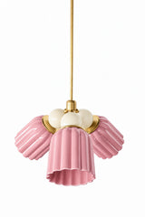 A pink chandelier that proves color can be sophisticated, not just sweet. The Marcella Small Chandelier pairs three fluted, scalloped ceramic shades in pastel pink with a cluster of cream glass globe bulbs and brass hardware for a grandmillennial look that reads collected, not cutesy. A great pick for a powder room, nursery, or any space that could use a little romance and color.
