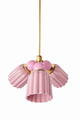 A small chandelier with glossy, glazed fluted ceramic cone shades in pastel pink, paired with blush pink connector balls and brass hardware. The two close tones of pink keep this fixture soft and cohesive rather than contrasting, a sweet but grown-up option for a nursery, a romantic bedroom, or a grandmillennial-leaning space that wants pink without any bold competing color.