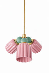 A pink and green chandelier that feels more garden party than nursery. The Marcella Small Chandelier pairs three fluted, scalloped ceramic shades in pastel pink with a cluster of vista green glass globe bulbs and brass hardware, an unexpected color combination that reads collected and a little botanical rather than saccharine. A fun pick for a breakfast nook, powder room, or colorful bedroom.