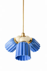 A blue and cream chandelier that keeps color classic rather than loud. The Marcella Small Chandelier is built from three fluted, scalloped ceramic shades in glossy sky blue, each attached at a round brass collar and flaring into a wavy, bell-shaped hem, arranged around a central cluster of cream glass globe bulbs on a brass stem. An easy, versatile pick for a nursery, bathroom, or breakfast nook that wants color without much risk.