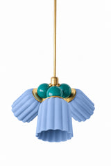 A blue and green chandelier with a coastal, jewel-toned edge. The Marcella Small Chandelier pairs three fluted, scalloped ceramic shades in dusty matte blue with a cluster of mermaid green glass globe bulbs and brass hardware, a color combination that reads collected and a little watery rather than expected. A great fit for a bathroom, breakfast nook, or any room that wants color without leaning too sweet.