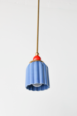 pastel light blue celadon-style glazed ribbed pendant light with poppy red-orange powdercoated ball and brass hardware.  Art deco inspired pendant light fixture. Made in New Orleans by Sazerac Stitches
