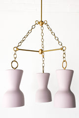 lavender porcelain and brass modern chandelier with ceramic shades and real brass chains and rods.  European inspired chandelier that has a slightly mid-century modern silhouette in a muted & delicate shade of lavender.  Perfect dining room chandelier.  Great ceramic & brass chandelier for minimalist, European inspired, mid century modern, eclectic, and Scandinavian style interiors.  Made in New Orleans by Sazerac Stitches.