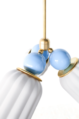 A close-up look at the Marcella Small Chandelier in unglazed cream and celestial blue, showing the matte finish of the fluted ceramic shades against the glossy blue connector balls and brass trim rings. The soft, light palette makes this a strong fit for a nursery, a coastal-leaning bedroom, or a gentle grandmillennial space that wants delicate color without heavy contrast.