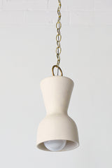 Cream and brass chained ceramic pendant lighting fixture. Made in the USA hand-cast tinted porcelain pendant kitchen light with real raw brass chain.  Beautiful unglazed porcelain ceramic pendant ceiling light fixture. 