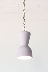 Pastel purple and brass chained ceramic pendant lighting fixture. Made in the USA hand-cast tinted porcelain pendant kitchen light with real raw brass chain.  Beautiful unglazed porcelain ceramic pendant ceiling light fixture. 