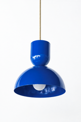 Vivid cobalt is the blue that makes a kitchen feel bold, sunny, and a little Mediterranean, and this Taeuber pendant leans right into it. The two-part silhouette stacks a rounded cup over a wide domed bell, all finished in a glossy Mediterranean blue with a warm brass stem, shown here lit and glowing. It reads saturated and confident, the kind of statement lighting that turns an island, breakfast nook, or sink into a real focal point. Hang one as a jolt of color or a row for maximum impact. A great choice f