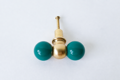 Another close look at the mermaid green double-ball drawer pull, with the brass center ball and mounting screw both visible. A clear reference shot for anyone comparing this teal-green colorway against their own cabinetry.