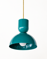 rich emerald green & brass bold geometric pendant light with a dome shade. glossy finish. Great kitchen pendant light. Good for small spaces or small dining tables. Bold, mid-century modern style pendant light that is great for maximalists or eclectic style decor. 