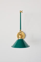 Emerald Green and Brass adjustable cone sconce for kitchen lighting above windows or above open shelving cabinetry.  Also makes a great bedside reading light that frees up space on your nightstands. Comes in three finishes and over 30 colors for a custom look.  Available in neutrals or fun, bright colors that work in any maximalist or kid-friendly space.  Classic style wall sconce that has been updated by our curated color palette of brights, darks, and pastel hues.  Designed and made by Sazerac Stitches.