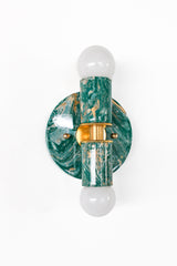Thalia sconce in mermaid green, cream, and gold marbled finish, variation A, with round backplate and brass center detail, fitted with two globe bulbs. Compact statement wall sconce or flush mount ceiling light for bathroom vanity lighting, powder room decor, coastal contemporary bedrooms, or pastel and jewel-tone interiors.