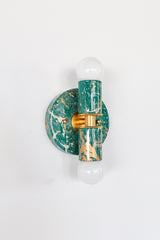 These marbled Thalia sconces feature one-of-a-kind swirls in mermaid green, cream, and gold tones, so no two pieces look exactly alike. The finish feels playful and luxe at the same time, pairing well with both neutral rooms and color-forward interiors.