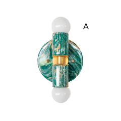 Mermaid green, cream, and gold marbled Thalia sconce option A with a glossy round backplate, brass center band, and two white globe bulbs. Compact two-light wall sconce or flush mount ceiling light for a pretty powder room, feminine bathroom vanity lighting, entryway, hallway, or bedside wall light in colorful modern and pastel interiors.