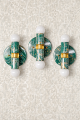 Set of three mermaid green, cream, and gold marbled Thalia wall sconces with brass accents and round backplates, each with two white globe bulbs, photographed on a white background to show the unique swirling pattern on every piece. Small modern bathroom lighting for a chic powder room, coastal glam, Art Deco inspired decor, or a colorful entryway.