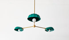 Art Deco-inspired coastal shell chandelier in green with brass accents