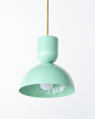 soft mint  & brass bold geometric pendant light with a dome shade. glossy finish. Great kitchen pendant light. Good for small spaces or small dining tables. Bold, mid-century modern style pendant light that is great for maximalists or eclectic style decor. 