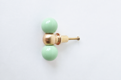 Another close look at the glossy mint green double-ball drawer pull, with the brass center ball and mounting screw both visible. Useful for comparing this soft pastel colorway against your own cabinetry.