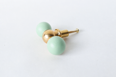 A closer, head-on look at the mint green double-ball drawer pull with its glossy finish and brass center ball. A clear reference for checking the exact shade and proportions before installing. Colorful drawer pull or cabinet pull for creative spaces and kid spaces.