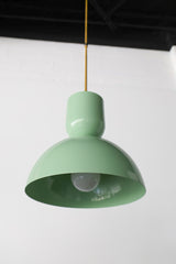 Sculptural mint and brass pendant light with a dome base and a dome top. Vibrant colored light fixture made in New Orleans by a small business. Brass details and brightly colored light fixture. 