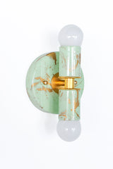 Small Thalia Sconces in a soft mint and cream hand-marbled finish with gold accents, photographed together to show the natural variation in each piece. The petite wall sconce has a playful but polished look, making it a lovely option for bathroom vanity lighting, small powder rooms, kids bathrooms, nursery bathrooms, or colorful guest baths. The marbled green finish pairs easily with brass fixtures, pastel tile, chinoiserie wallpaper, and grandmillennial decor.