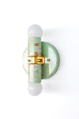 Hand-marbled Small Thalia Sconces in a soft mint, cream, and gold finish, shown as a product image with three slightly different marbled patterns. Each small two-light wall sconce has its own one-of-a-kind surface, with painterly swirls of pale green, ivory, and metallic gold. A pretty choice for muted kids bathrooms, small powder rooms, grandmillennial decor, chinoiserie-inspired spaces, cottage bathrooms, or colorful vanity lighting that still feels soft and refined.