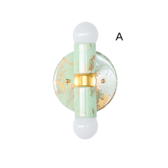 Small Thalia Sconces in a soft mint and cream hand-marbled finish with gold accents, photographed together to show the natural variation in each piece. The petite wall sconce has a playful but polished look, making it a lovely option for bathroom vanity lighting, small powder rooms, kids bathrooms, nursery bathrooms, or colorful guest baths. The marbled green finish pairs easily with brass fixtures, pastel tile, chinoiserie wallpaper, and grandmillennial decor.