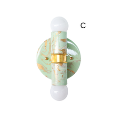 Three Small Thalia Sconces shown in a hand-marbled mint, cream, and gold colorway, each with unique swirls, veining, and painterly movement. The petite two-light silhouette works beautifully as bathroom vanity lighting, powder room wall lights, or playful sconces for a kids bathroom. The soft green palette feels fresh and muted, while the gold details add warmth for grandmillennial, chinoiserie, cottage, and eclectic interiors.