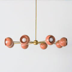Peach and Brass mid century modern large chandelier with peach colored shades.  Adds a ton of light and style with a pop of Pantone's 2024 color of the year, peach fuzz.