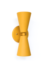 A warm, retro double-cone wall sconce for a hallway, bar, breakfast nook, or mid-century modern room that wants earthy color and crisp, two-directional light. The Dryades sconce pairs an upward and a downward mustard cone at a narrow waist, mounted on a round mustard backplate with brass screw accents. Golden, ochre-toned, and a little 70s, its bowtie silhouette makes a confident statement in retro, eclectic, and warm traditional spaces.