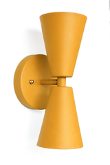 A statement wall sconce for rooms that lead with warm, earthy color and sculptural shapes. Seen from an angle, the Dryades sconce shows off its mustard double-cone silhouette — one cone throwing light up, one down — meeting at a narrow waist on a round mustard backplate. Golden, retro, and a little Art Deco, it's a confident pick for hallways, bars, breakfast nooks, and mid-century or 70s-inspired interiors that want warm color with crisp lines.