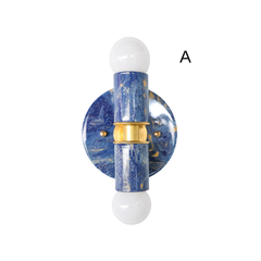 This version of the blue marbled Thalia sconce features layered shades of cobalt, navy, and lighter blue with subtle gold accents and brass hardware. The marbled pattern has a water-like, ocean-inspired quality that makes it a strong fit for coastal, eclectic, or maximalist interiors. Its compact scale makes it especially useful for bathrooms, hallways, and other smaller spaces.