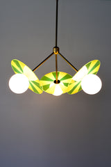 Playful pendant light casting a soft glow, available in Bright Blue, Medium Pink, or Neon Green.