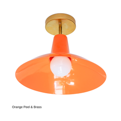 The Bruxelles Flushmount in Orange Peel brings a citrusy jolt of color to a fixture built for ceilings that can't fit a hanging pendant. The wide, angled shade and warm brass hardware keep it feeling architectural rather than loud, making it a strong pick over a kitchen island, in an entryway, or lighting a hallway, laundry room, or playroom where you still want real color overhead.