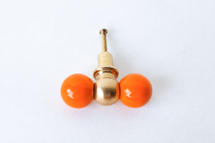 A closer, head-on look at the orange peel double-ball drawer pull, showing the brass center ball and glossy finish in detail. Useful for checking the exact shade and proportions before installing.