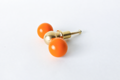 Another close look at the orange peel double-ball drawer pull, with the brass center ball and mounting screw both visible. A clear reference shot for comparing this bold colorway against your own cabinetry.